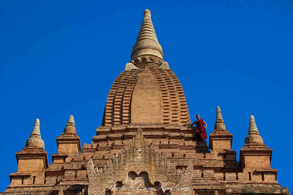 A monk on the top of a stupa