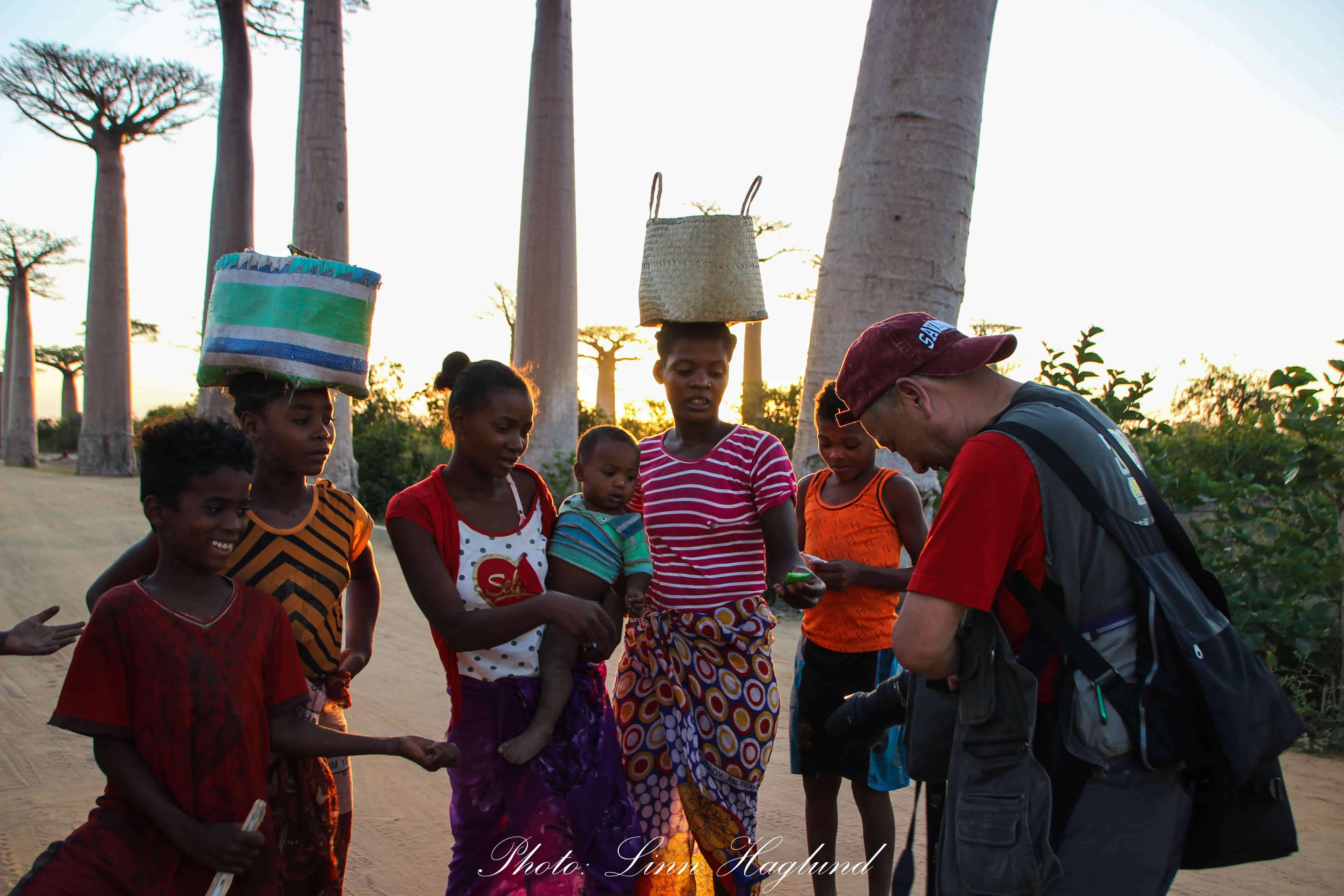 Tourist giving gifts to Malagasys