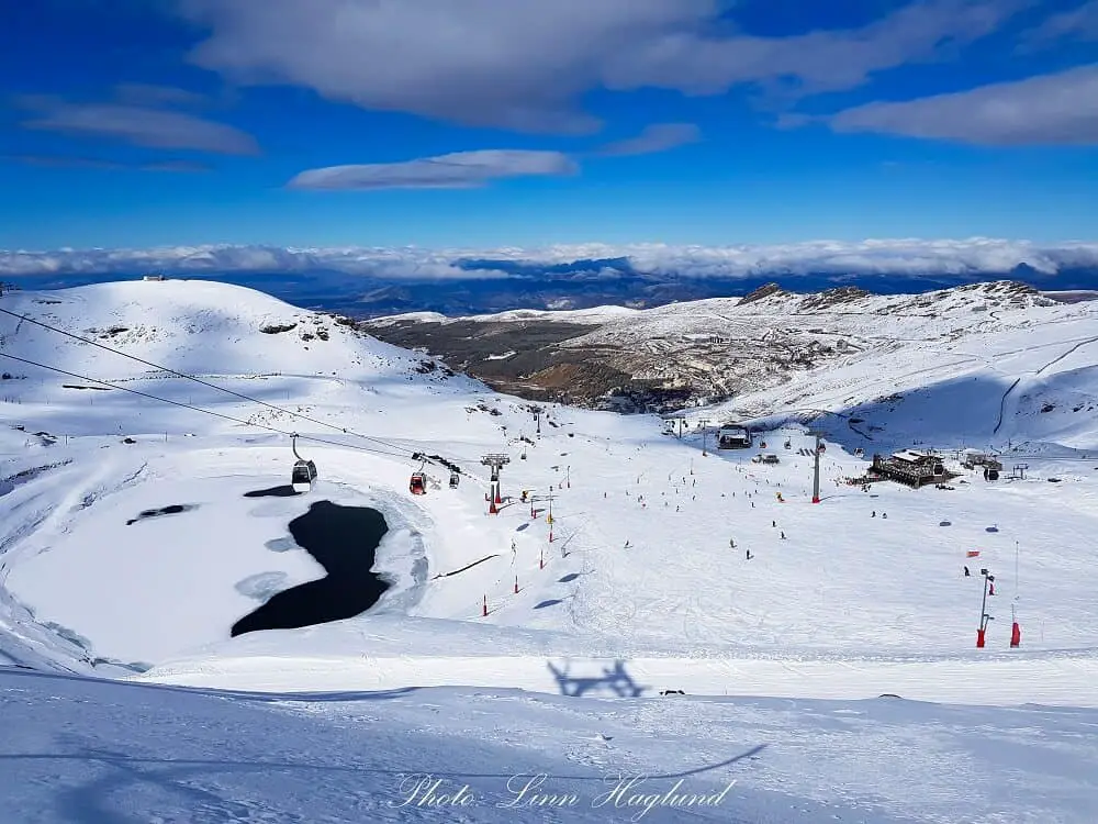 A snow capped Sierra Nevada views in winter seen from the top of the skiing slopes.