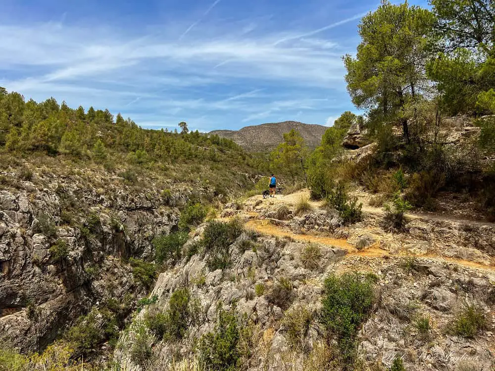 Me and my dog hiking on the edge of a deep ravine at one of the Best Hikes in Spain.