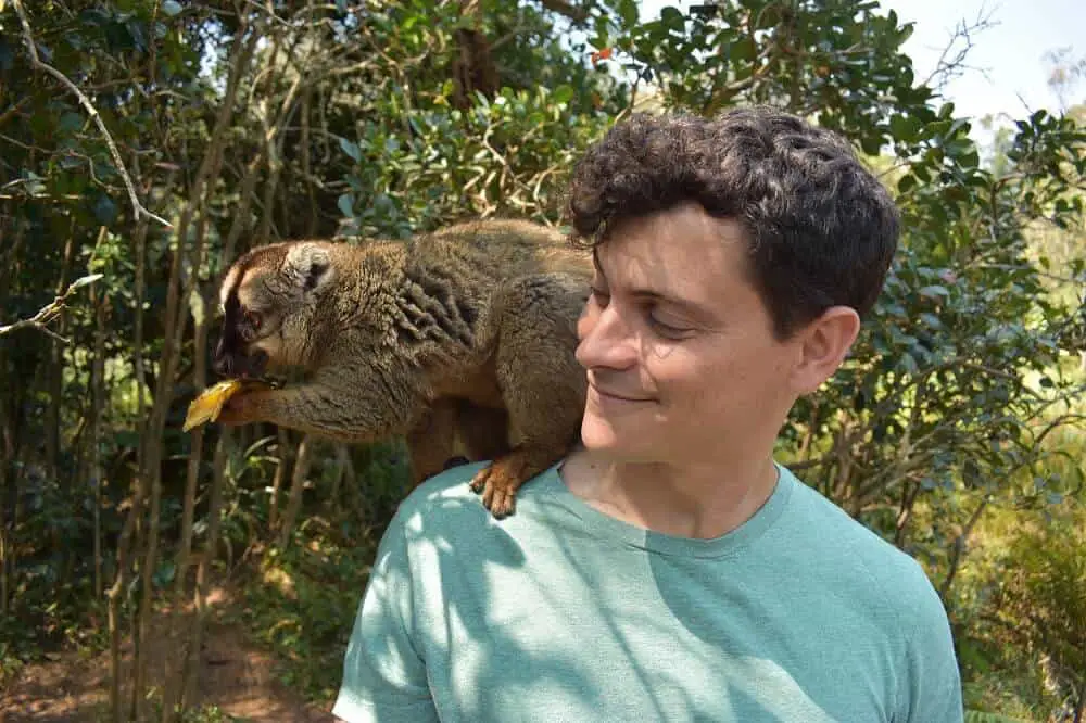 Nomadic Matt with a lemur on his shoulder