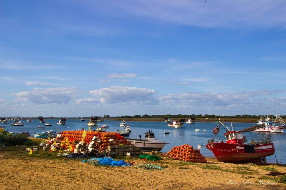 Colorful fishing boats on the Punta Umbria river side. It's a sunny and beautiful day.