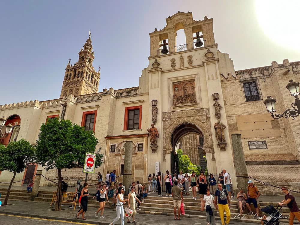 Seville Cathedral with people walking in the front.