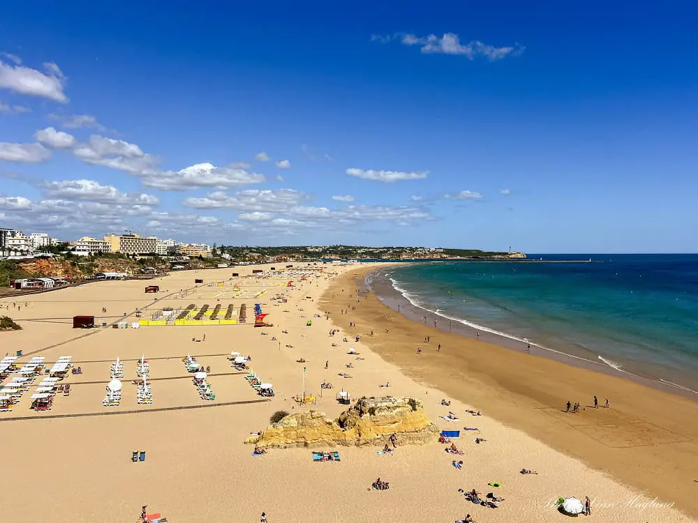 A long, wide beach in Portimão Portugal.