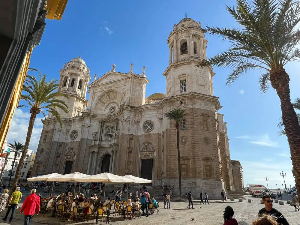 A busy square in front of Cadiz Cathedral with its two clock towers. Visiting the cathedral is a must on any Cadiz itinerary.