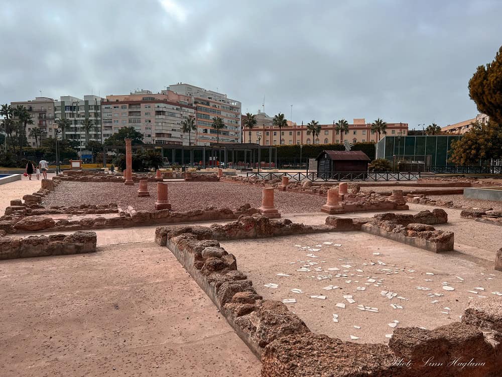 Ancient Roman house ruins in Jardín Erytheia Valera Norte, Cádiz, Spain, showcasing archaeological remains. This is one of the lesser-known hidden gems in Cadiz, Spain, surrounded by urban greenery and apartment blocks.
