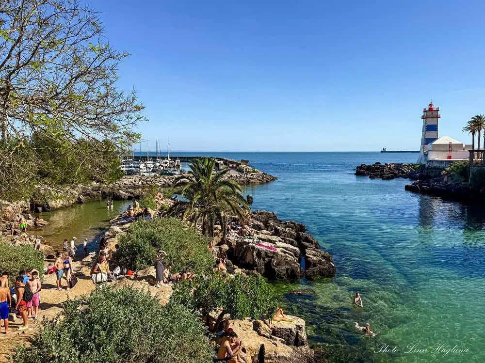 People swimming on a summer day in Cascais.