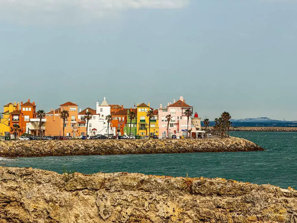Colorful houses at Puerto Sherry in El Puerto de Santa Maria Cadiz. The marina is surrounded by epic beaches and is a popular spot to go out for drinks and food.