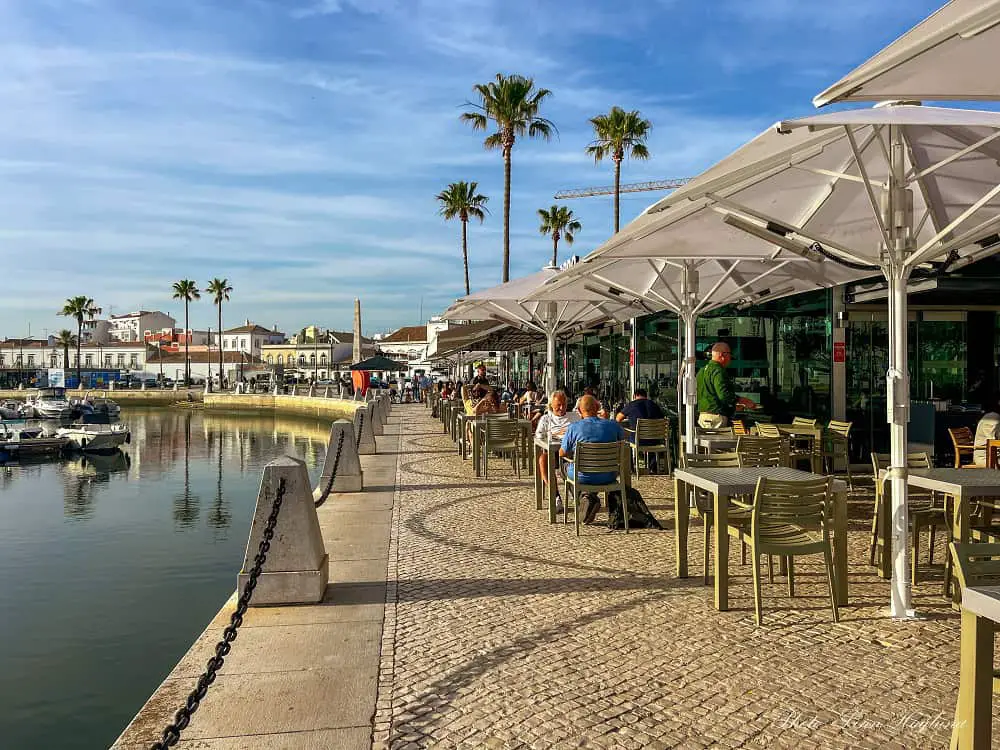 Faro Marina with restaurants with people drinking and eating.