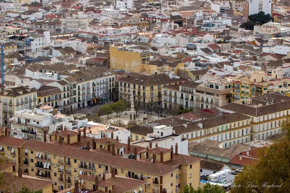 Houses and streets around a square which is one of the best places to stay in Malaga, Spain.