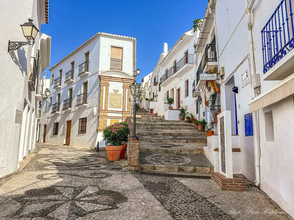 Hilly, cobbled streets through whitewashed houses in Frigiliana - a great Nerja day trip.