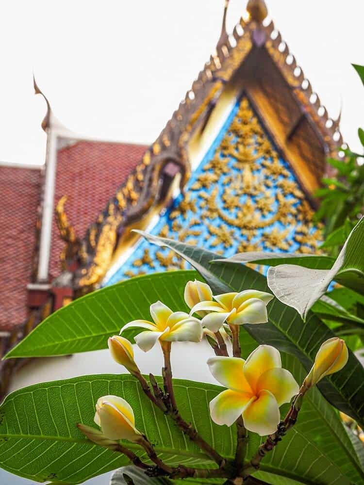 Beautiful temple with flowers in the foreground - a must visit on a Bangkok 2 day itinerary
