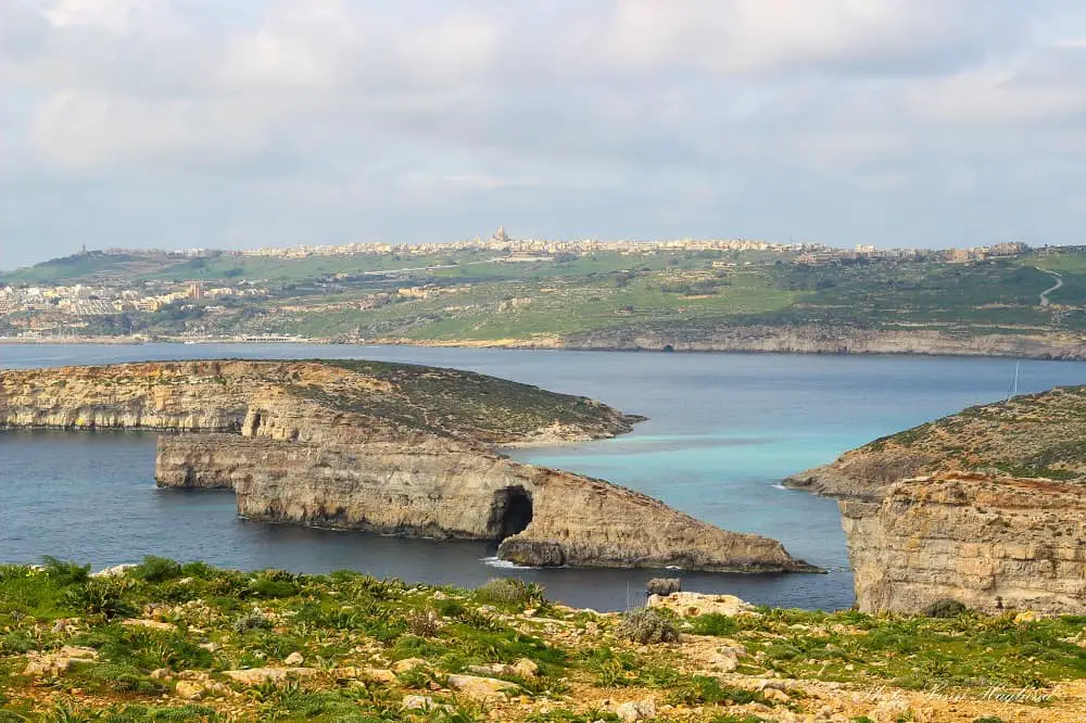 Green grass and rugged cliffs on Comino Island which is a must when spending 3 days in Malta.