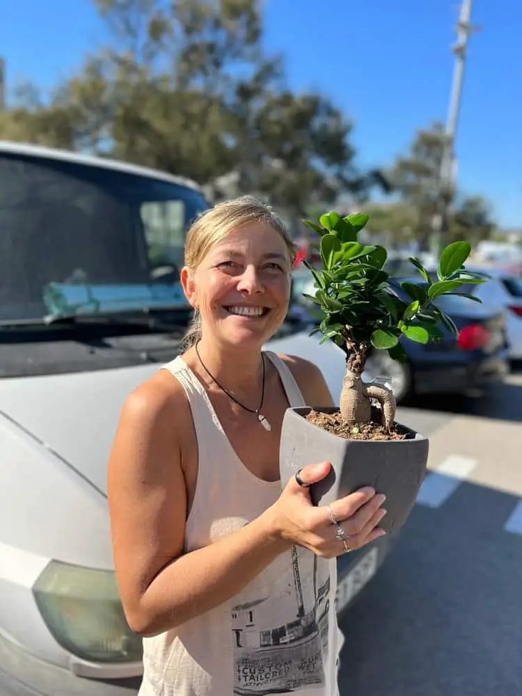 Me holding Lisa the traveling Bonsai in front of Persi the van.