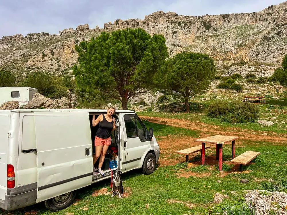 Me and Atlas outside Persi the van in beautiful natural surroundings and mountains in the background.
