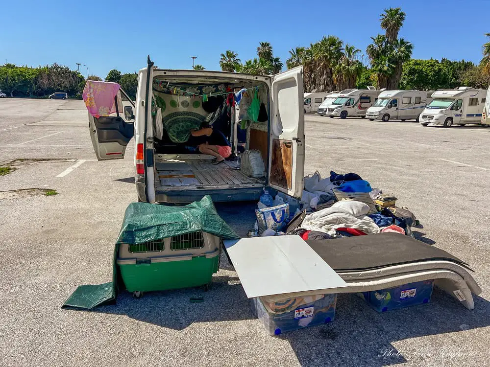 Cleaning out the van with all our belongings outside.