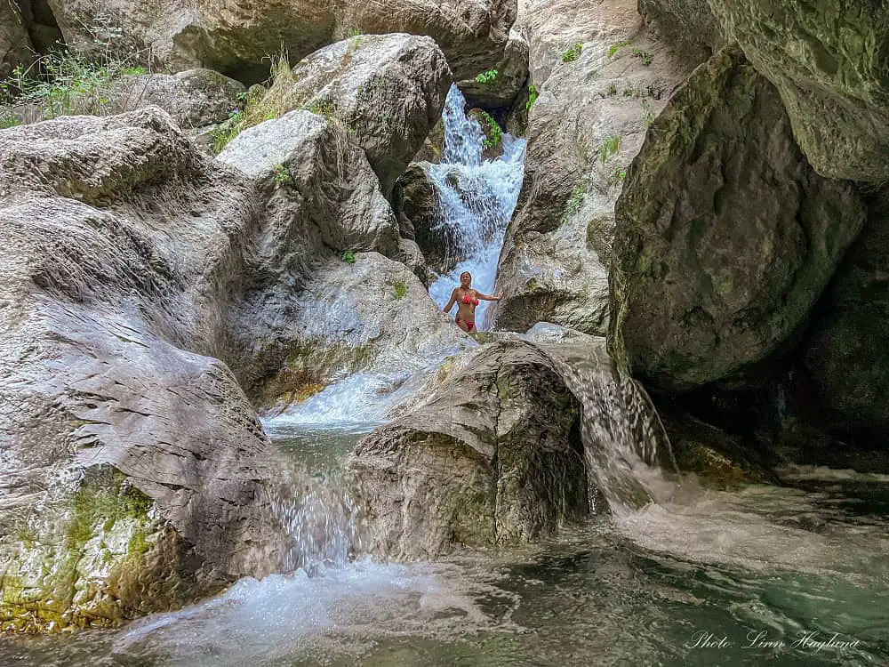 Me standing under the biggest waterfall in Ruta de Los Bolos.