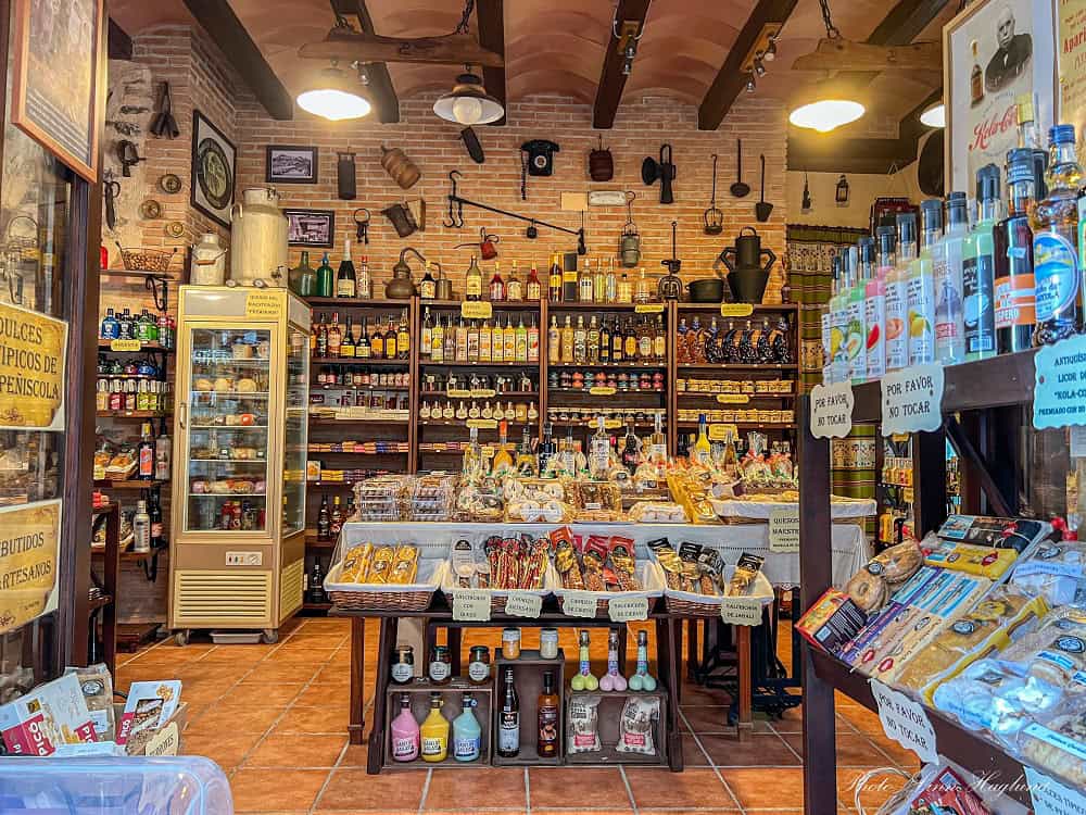 Shop filled with wines, liquors, and olive oil bottles in Peñiscola.