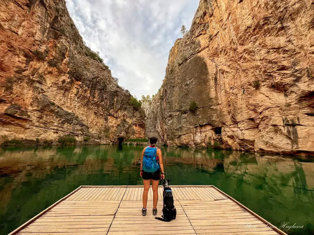 Me and Atlas standing on the wooden jetty in Charco Azul surrounded by the walls of a deep gorge.