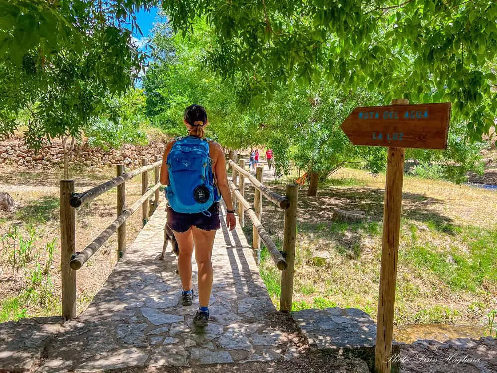 Me walking across the small bridge at the Ruta del Agua y Aqueducto de la Peña Cortada Chelva trailhead.