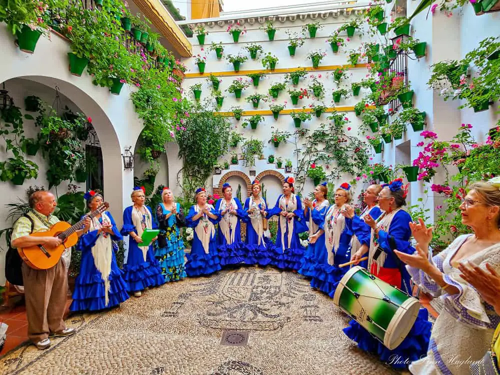 A group of dancers in blue flamenco dresses during Cordoba Patio Festival.