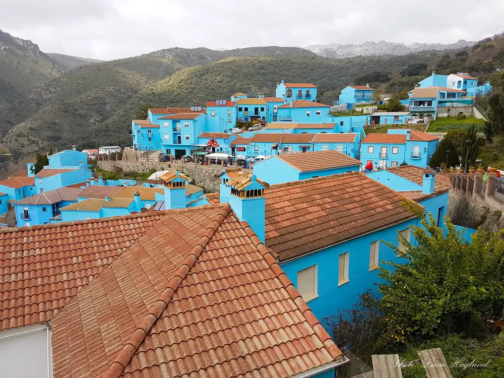 Juzcar the Smurf village with blue painted houses on a cloudy day.