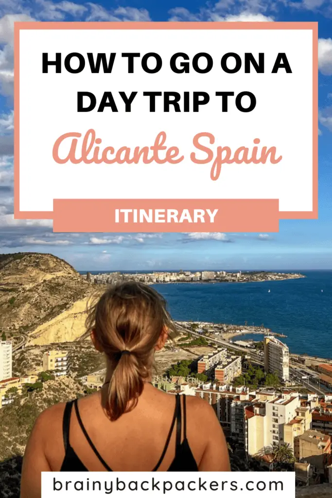 Pinterest image with a picture of me looking at the views of Alicante from the castle and overlay text saying:"Day Trip to Alicante Spain".