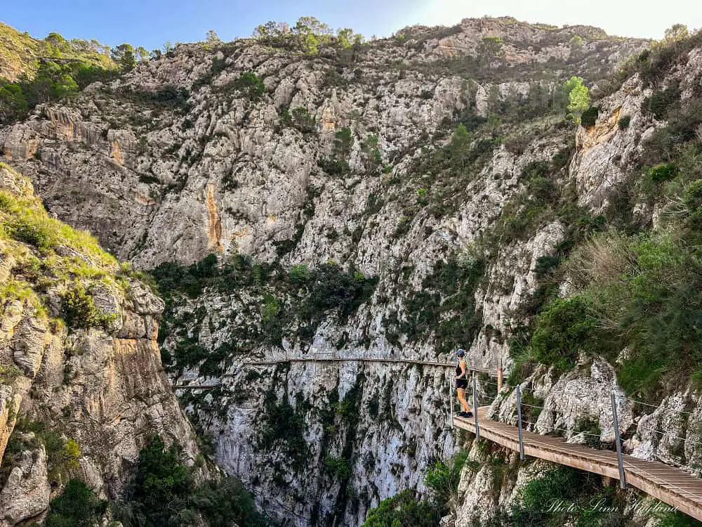 Me hiking Pasarela de Relleu Alicante, a wooden path pinned 60 meters high on a vertical gorge wall.