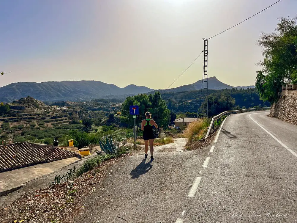 Me taking a left turn down a dirt path from the road to hike Pantano de Relleu.