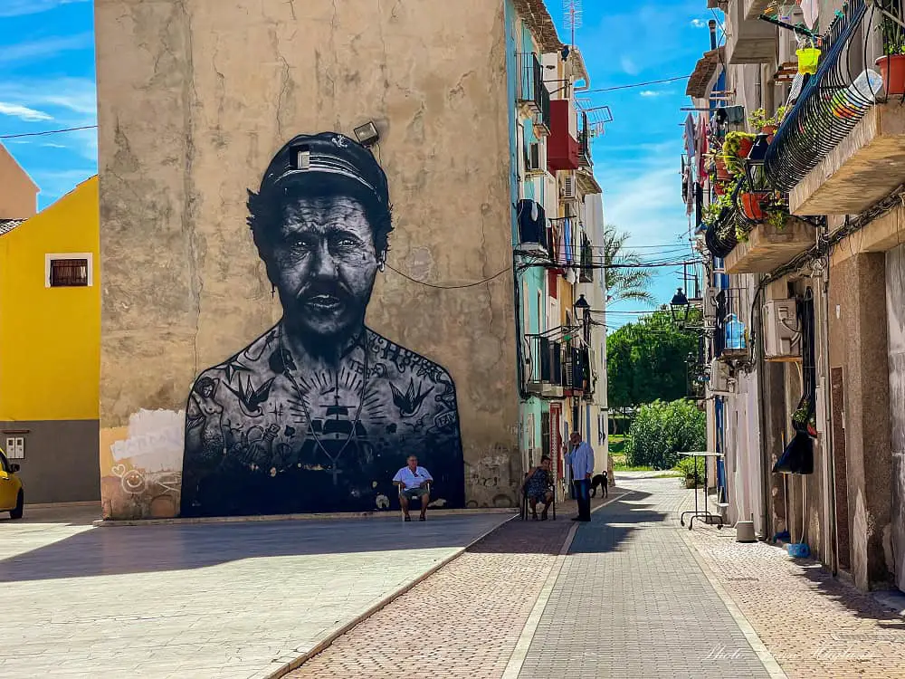 Street art of a sailor with tatoos all over his bosy in Villajoyosa Spain.