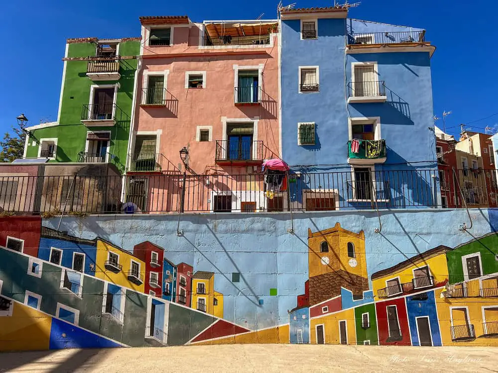 Things to do in Villajoyosa - colorful houses and colorful wall paintings depicting the colorful houses.