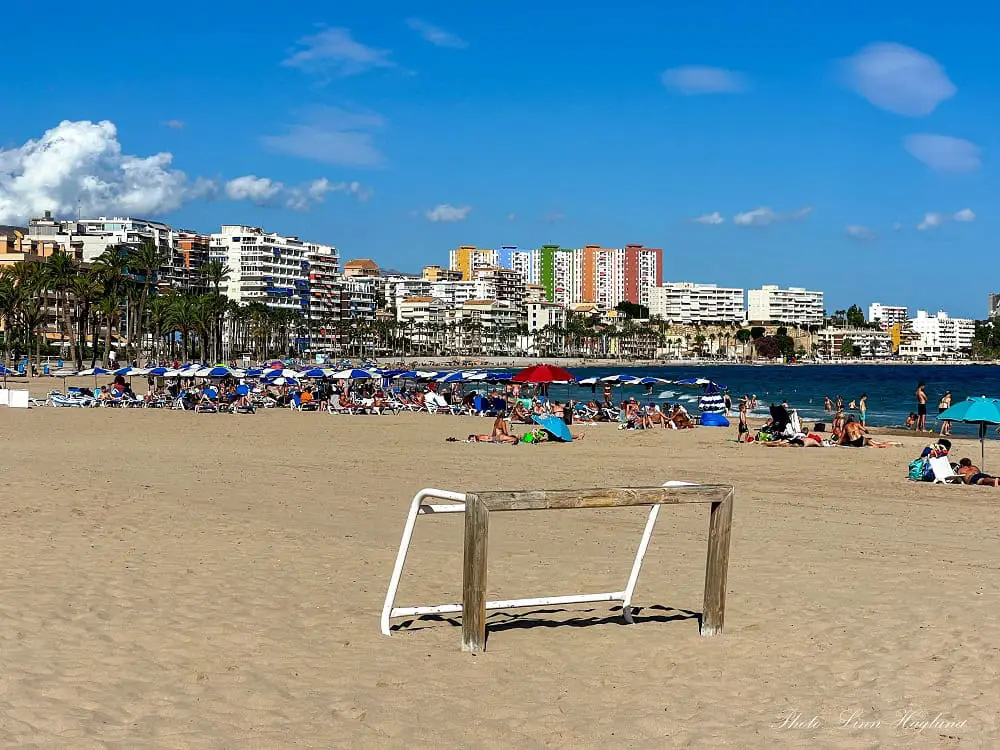 Peaople sunbathing at Villajoyosa Beach.