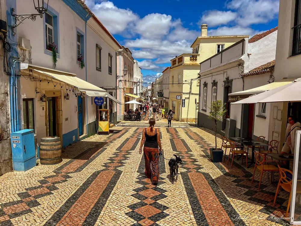 Me walking with Atlas on a pedestrian street in Lagos Portugal.