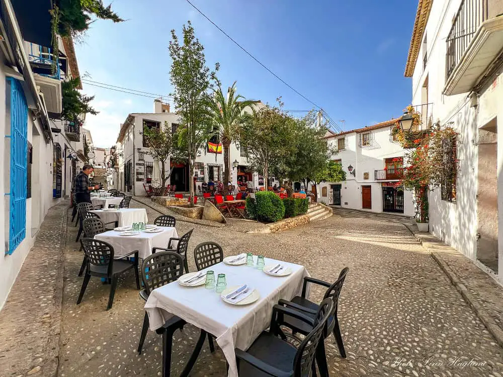 A beautiful square in Altea with restaurant tables.