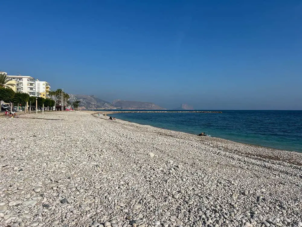 Beach in Altea Spain made of white rocks and pebbles.