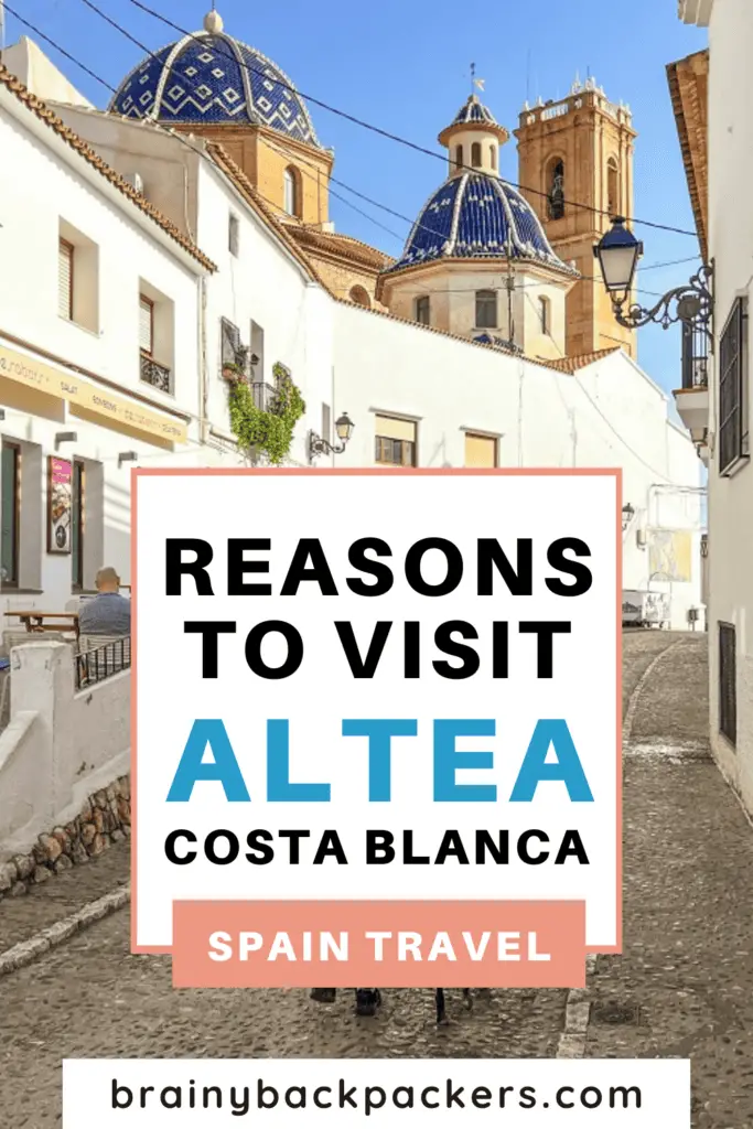 Pinterest image with a picture of a cobbled street leading to a church tower and a blue dome with the overlay text: "Is Altea Worth Visiting?"