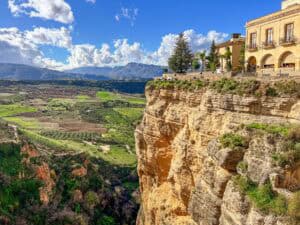 A house on top of a steep cliff, seen on one of the best Fuengirola day trips to the town of Ronda.