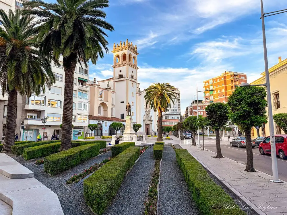 Palm trees on a square before a church at Plaza Minayo Badajoz.