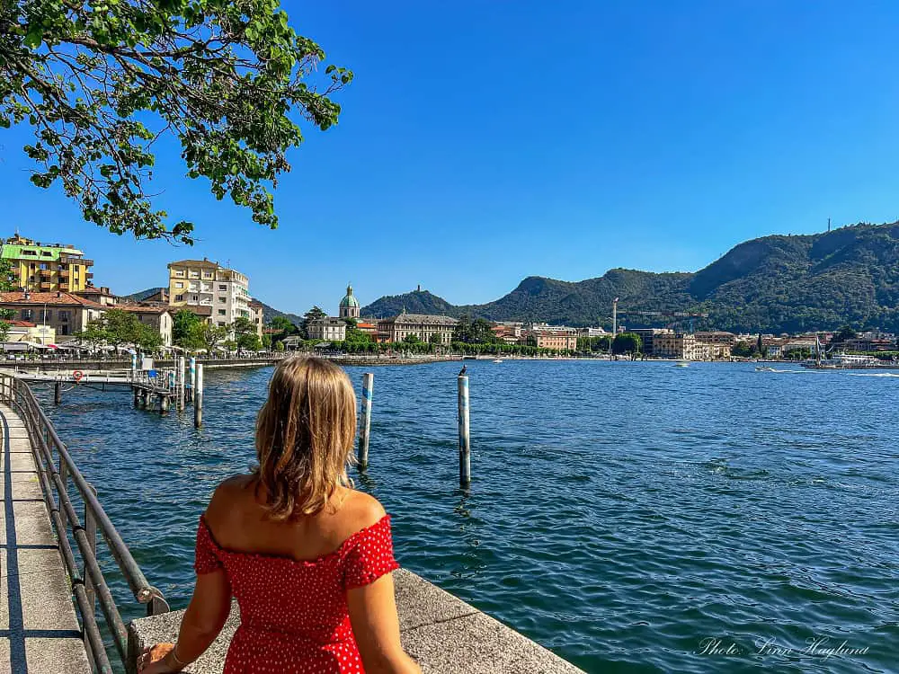 Me, in a red dress, looking at the beautiful, sunny lakefront in Como. If you have one day in Como, make sure you take a stroll around the lakefront for these views.