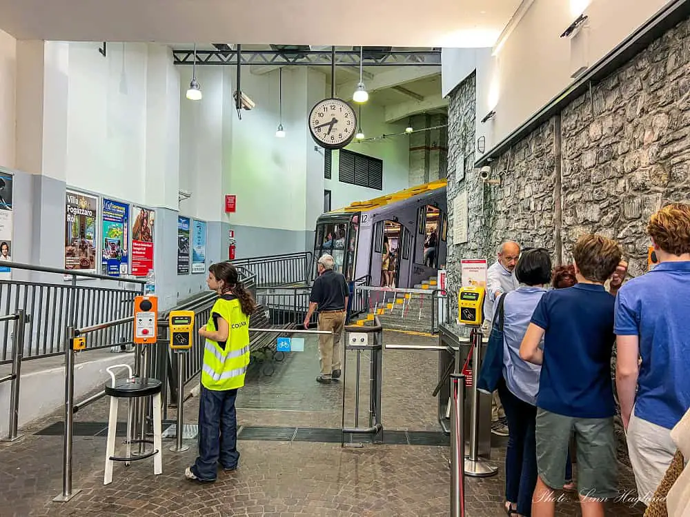 People in a que to enter the funicular to Brunate from Como in north Italy.