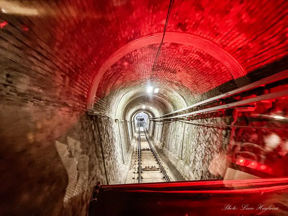 Tunnel on the Como Brunate funicular ride in Lake Como Italy. There's a red light in the tunnel and it's a steep slope from the bottom to the funicular.