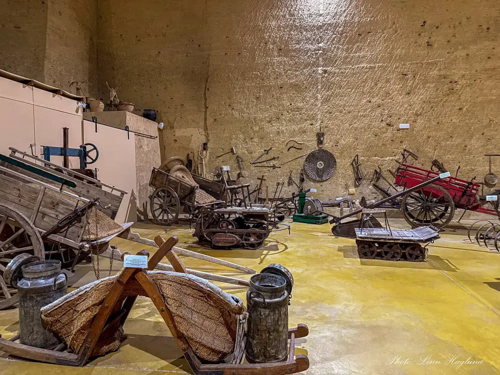 Old farming tools that are exhibited inside Coto de las Canteras in Osuna Spain. There are wooden wagons and tools to carry water and milk, as well as other primitive transporting tools.